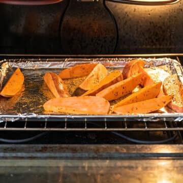 Tray of wedges being baked in oven.