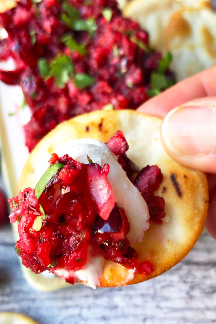 Closeup shot of cracker with spicy Cranberry Dip and cream cheese. 