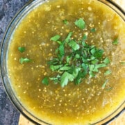 Bowl of homemade Mexican salsa verde or green tomatillo salsa- Overhead shot.
