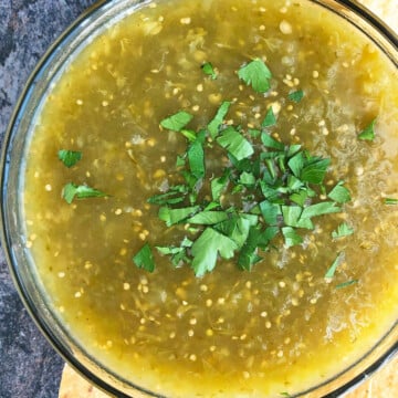 Bowl of homemade Mexican salsa verde or green tomatillo salsa- Overhead shot.