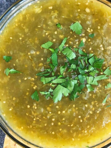 Bowl of homemade Mexican salsa verde or green tomatillo salsa- Overhead shot.