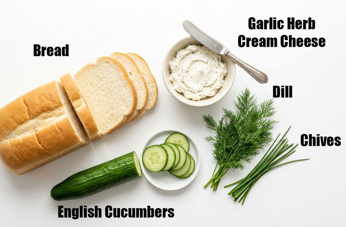 Ingredients for recipe on white background- bread, cucumbers, flavored cream cheese, fresh herbs. 