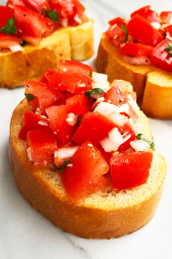 Easy Homemade Bruschetta With Tomatoes on White Marble Background. 