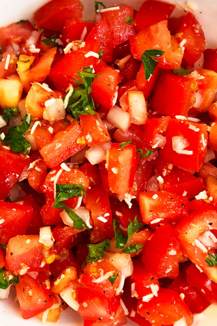 Closeup shot of Italian tomato dip in white bowl. 