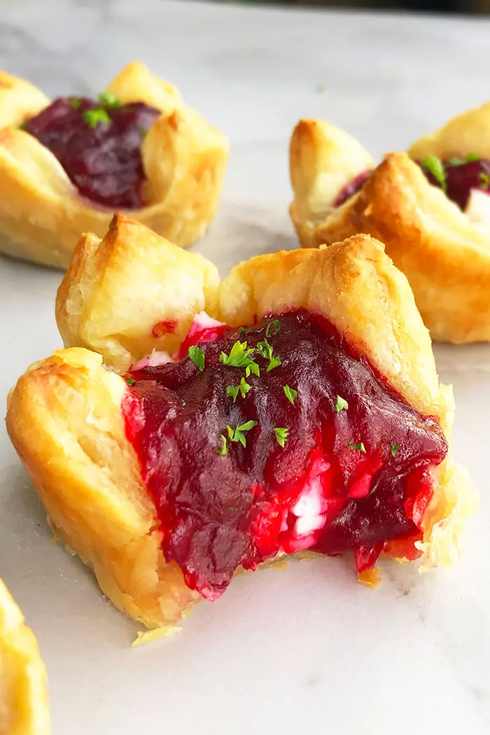 Closeup of Baked Brie Appetizer with Cranberry Sauce- With a Bite Removed