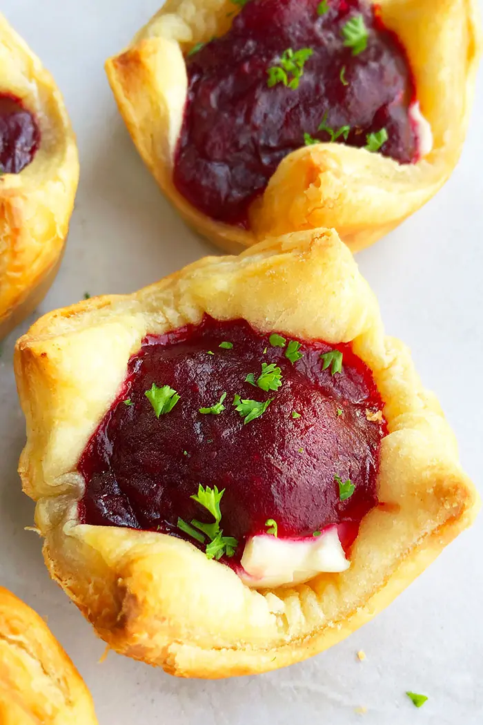 Baked Puff Pastry Cranberry Brie Bites on Marble Backdrop