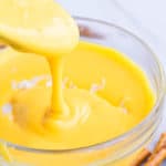 Spoonful of Homemade Cheese Sauce in a Glass Bowl