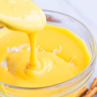 Spoonful of Homemade Cheese Sauce in a Glass Bowl