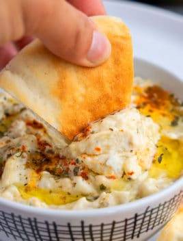 Pita Bread Being Dipped in Baba Ganoush