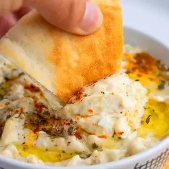 Pita Bread Being Dipped in Baba Ganoush