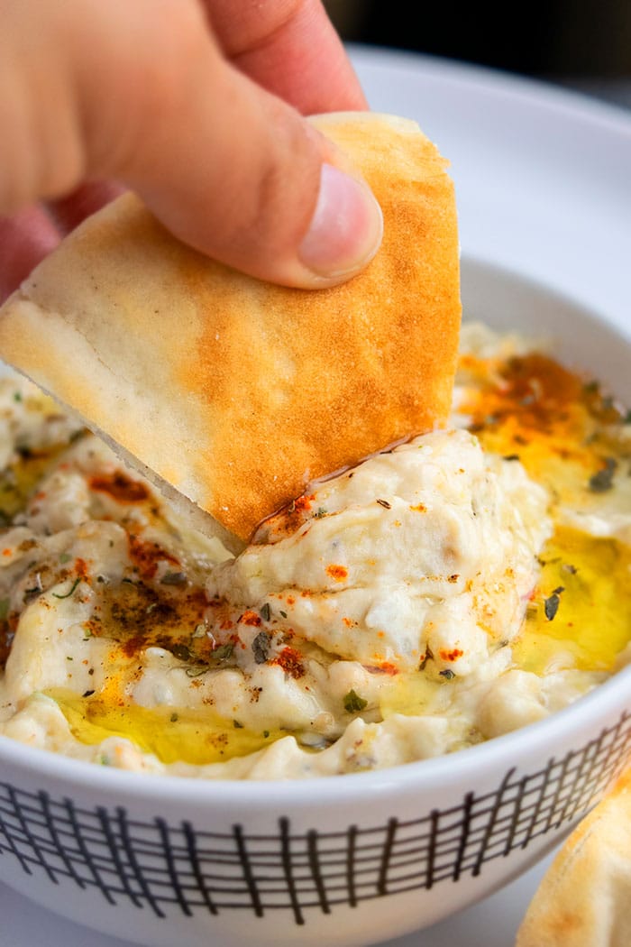 Pita Bread Being Dipped in Homemade Baba Ganoush