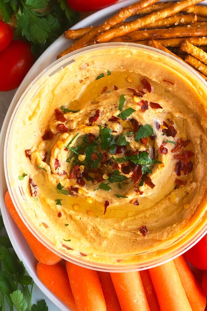 Homemade Roasted Red Pepper Hummus Dip on a Plate of Veggies.