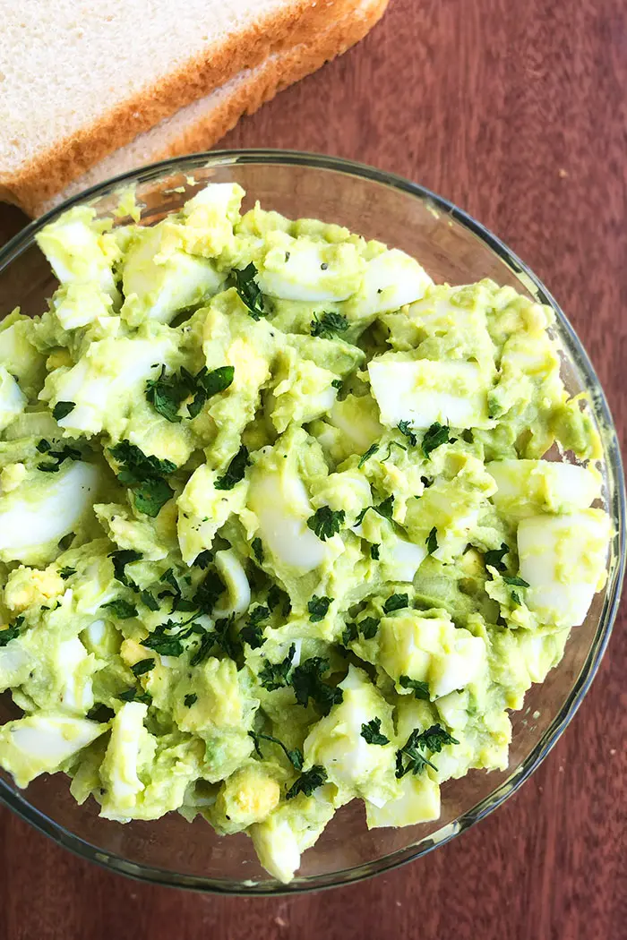 Bowl of Easy Homemade Avocado Egg Salad on Wood Board