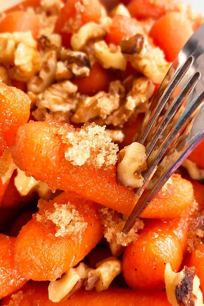 Fork with Candied Carrots Garnished with Brown Sugar and Nuts