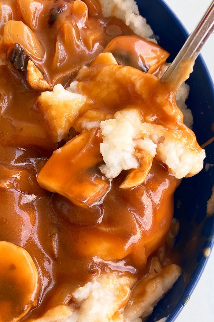 Closeup of Best Mushroom Gravy with Mashed Potatoes in Blue Bowl