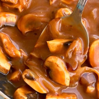 Spoonful of Easy Homemade Mushroom Gravy in Black Pot