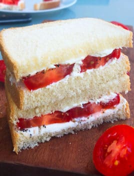 Stack of Fresh Tomato Sandwiches on a Wood Board