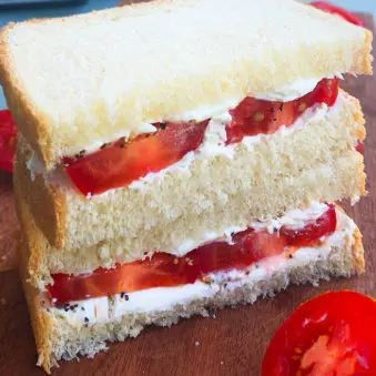 Stack of Fresh Tomato Sandwiches on a Wood Board