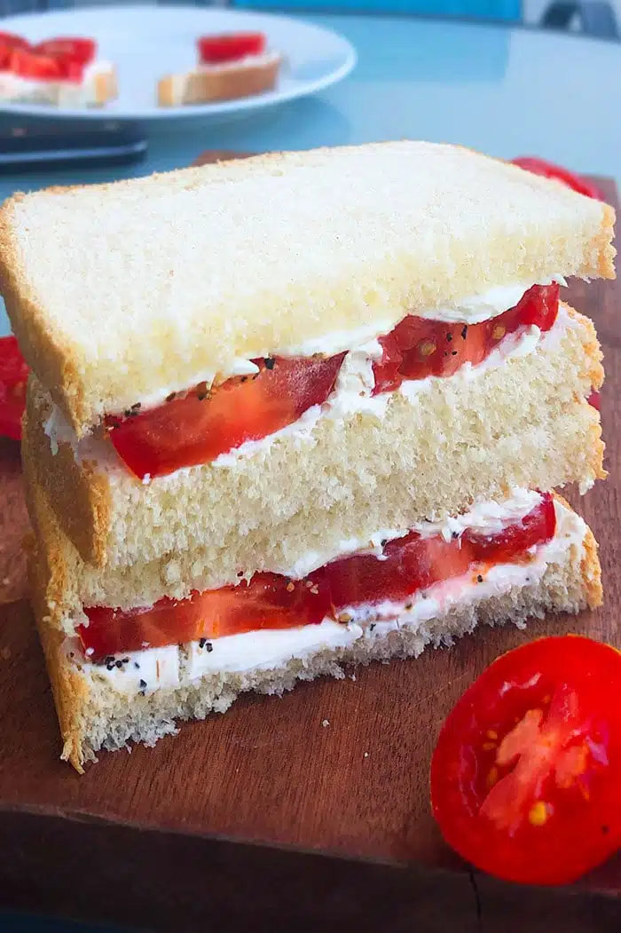 Stack of Fresh Tomato Sandwiches on a Wood Board