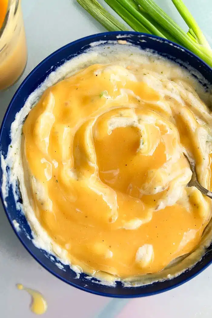 Homemade Vegetarian Gravy in Blue Bowl of Mashed Potatoes