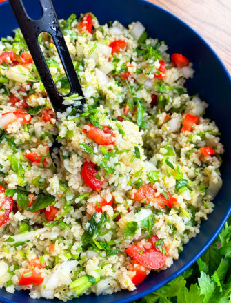 Spoonful of Easy Homemade Tabbouleh Salad in Blue Bowl