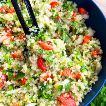 Spoonful of Easy Homemade Tabbouleh Salad in Blue Bowl