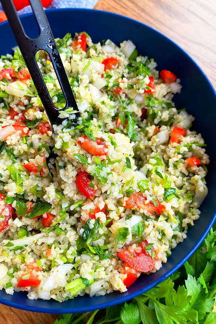 Spoonful of Easy Homemade Tabbouleh Salad in Blue Bowl