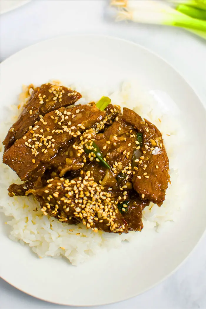 Overhead Shot of Easy Homemade Mongolian Beef With Mongolian Sauce and Rice in White Plate