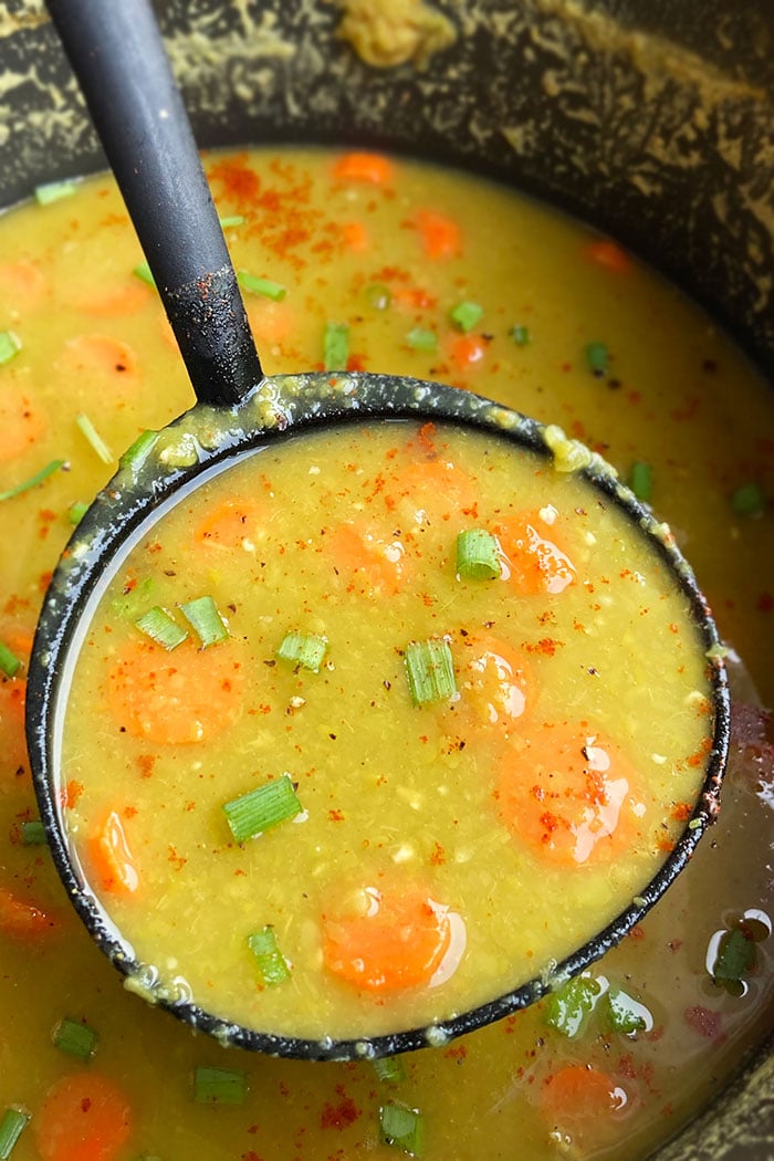 Spoonful of Homemade Split Pea Soup in Black Pot