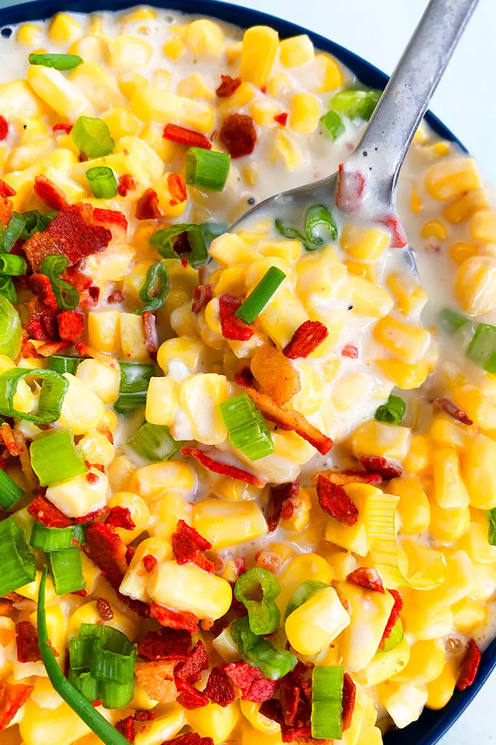 Closeup Shot of Spoonful of Cream Cheese Corn on White Background