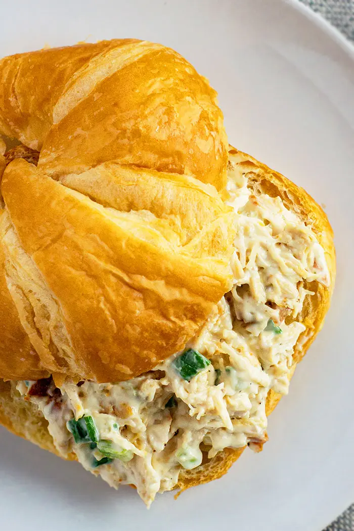 Old Fashioned Leftover Turkey Salad Sandwich With Croissant on White Plate- Closeup Shot