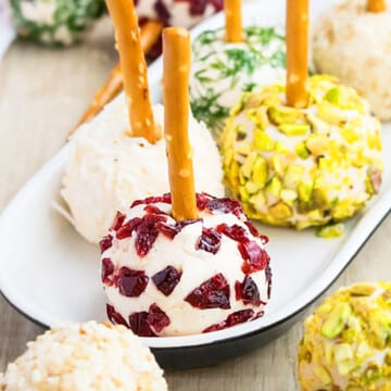 Easy Mini Cream Cheese Balls on White Plate With Various Toppings.