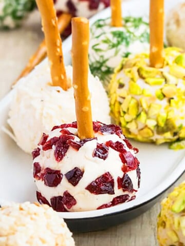 Easy Mini Cream Cheese Balls on White Plate With Various Toppings.