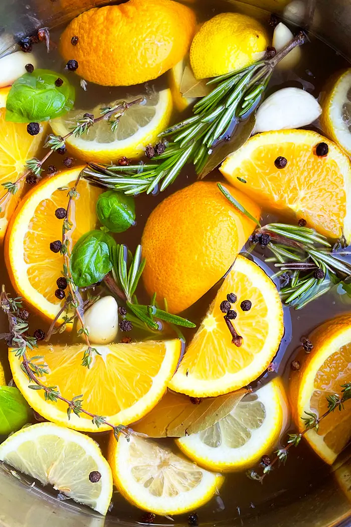 Closeup Shot of Apple Cider Turkey Brine with Fresh Herbs, Lemon Slices Orange Slices