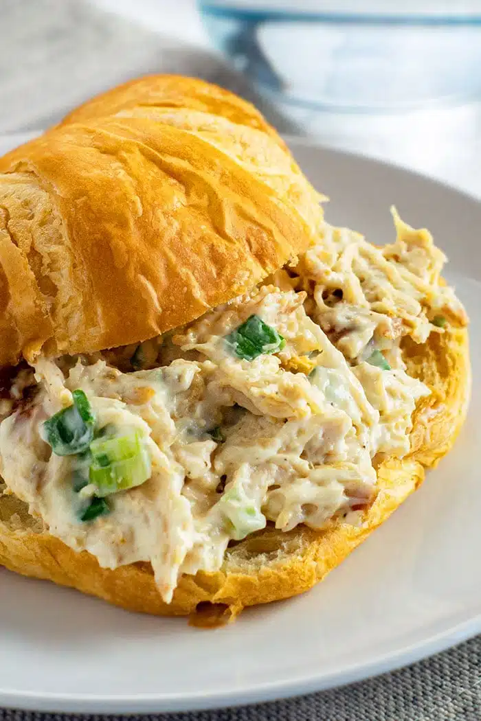 Easy Creamy Homemade Turkey Salad Filled in Croissant on White Plate