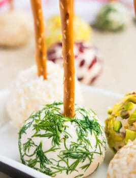 Easy Mini Cream Cheese Balls on White Plate With Various Toppings