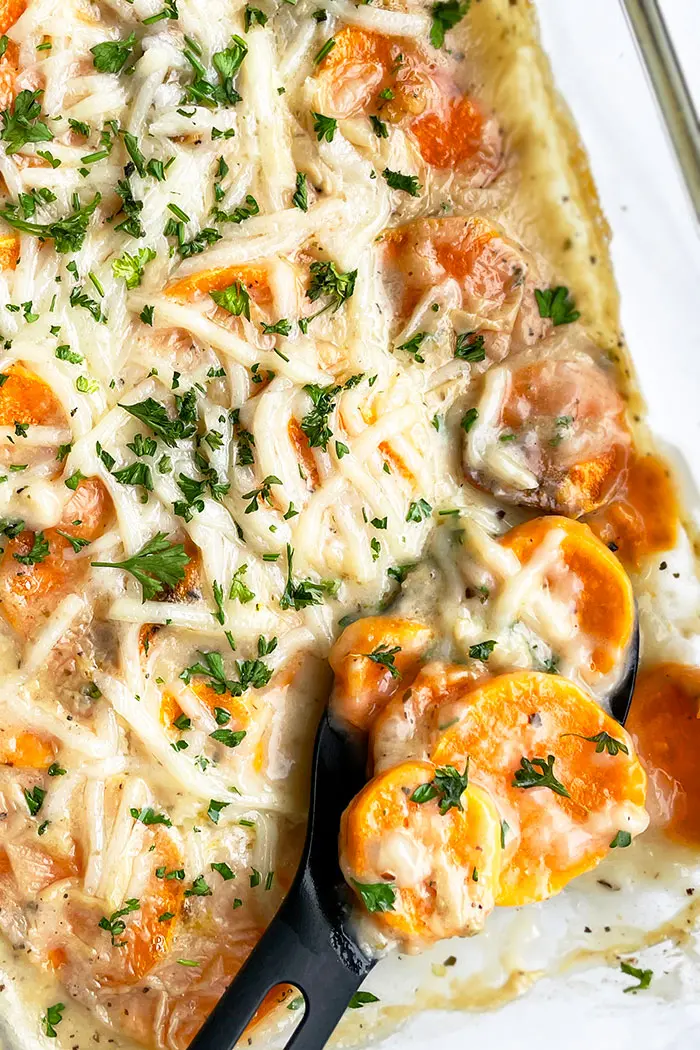 Overhead Shot of Sweet Potatoes au Gratin in Glass Dish on White Surface