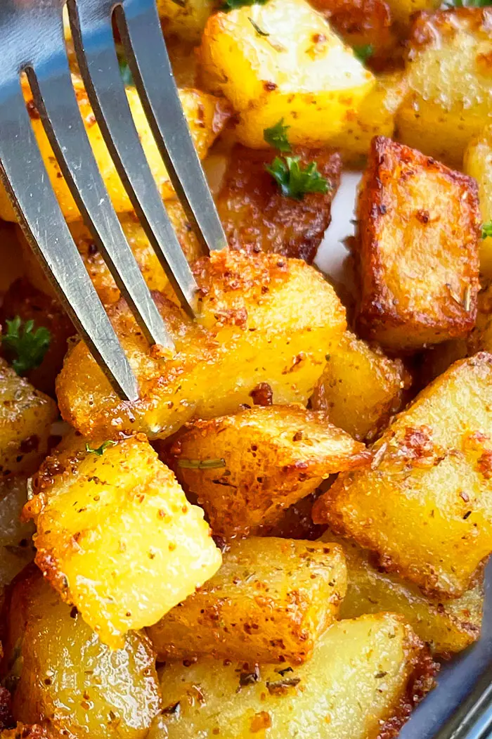 Silver Fork With Oven Baked Breakfast Potatoes- Closeup Shot