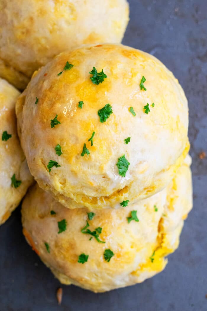 Overhead Shot of Easy Homemade Cheese Stuffed Rolls, Topped with Garlic Butter- On Black Baking Tray.