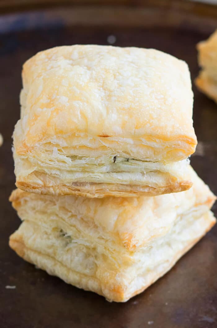 Stack of Stuffed Savory Puff Pastry  Appetizer on Rustic Black Tray. 