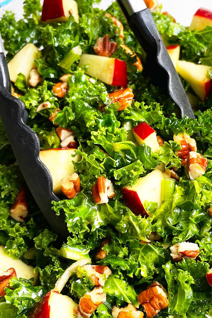 Closeup Shot of Massaged Kale Salad with Apples and Pecans