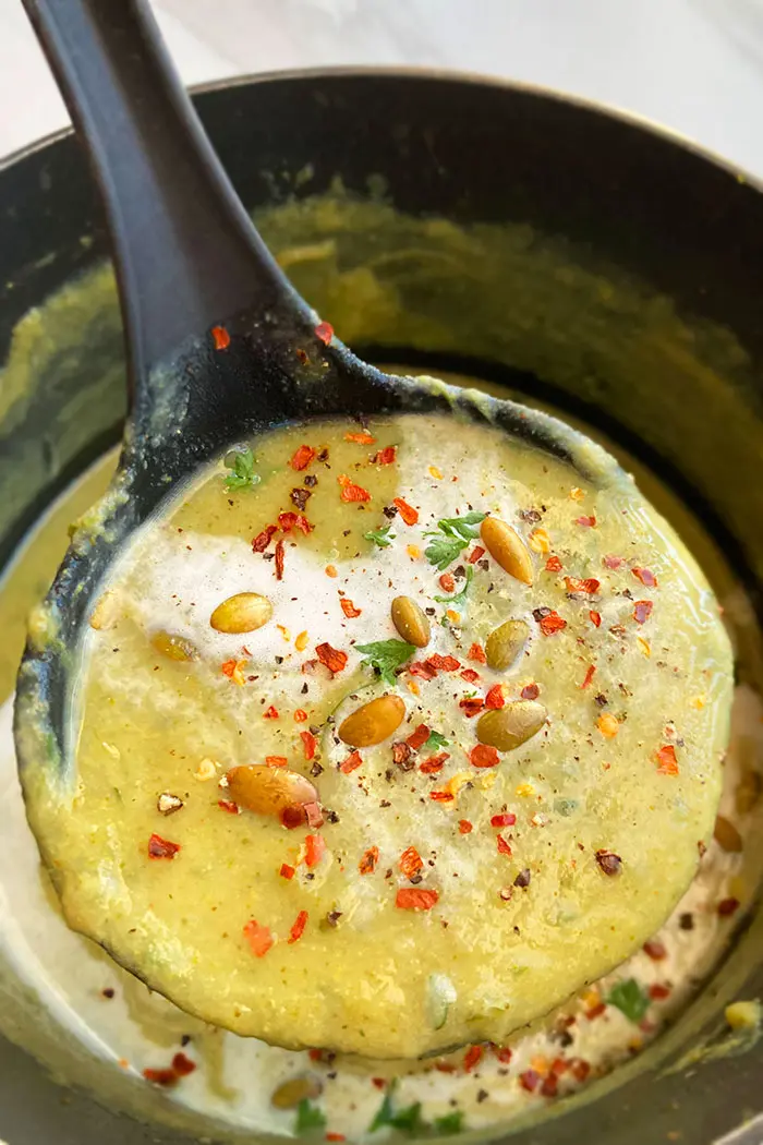 Spoonful of Easy Creamy Broccoli Soup in Black Pot