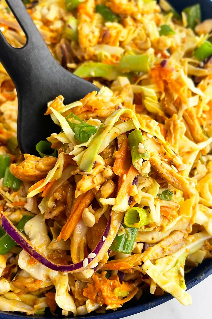 Spicy Thai Salad with Peanut Dressing In Blue Bowl- Closeup Angled Shot