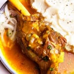 Instant Pot Lamb Shanks Served in White Plate with Mashed Potatoes on The Side