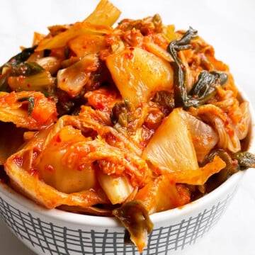 Best Easy Homemade Korean Kimchi Cabbage in White Bowl on White Background.