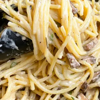 Tongs Full of Easy Creamy Mushroom Pasta