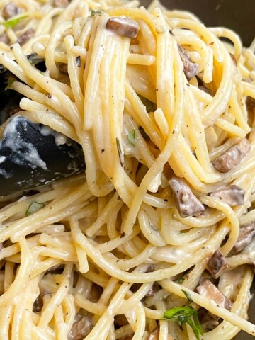 Tongs Full of Easy Creamy Mushroom Pasta