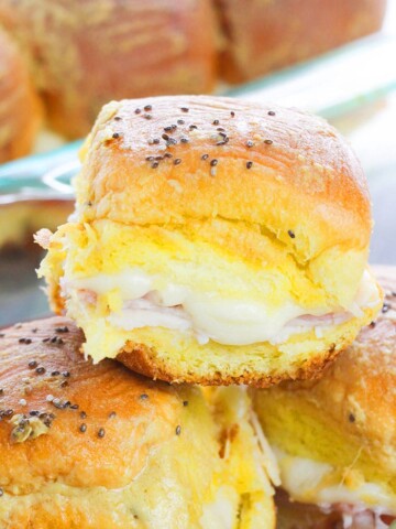 Easy Ham and Cheese Sliders Stacked on One Another in a Plate