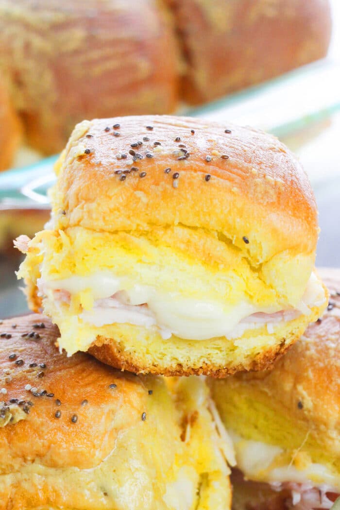 Easy Ham and Cheese Sliders Stacked on One Another in a Plate.