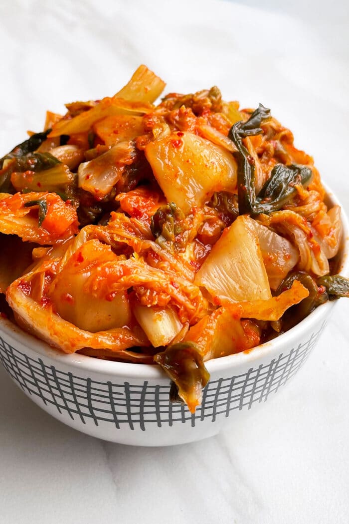 Easy Homemade Kimchi in White Bowl on White Background.